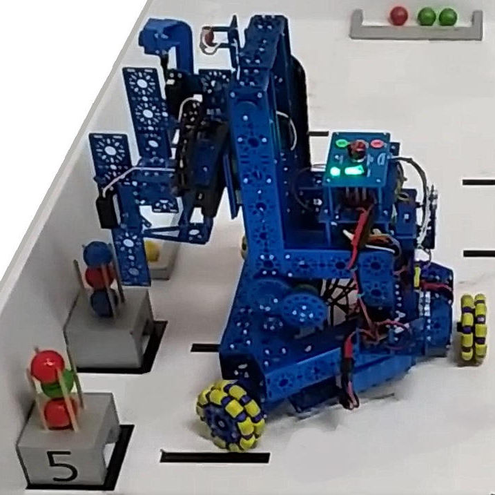 A mobile robot by Studica Robotics in action moving balls into different areas.  
