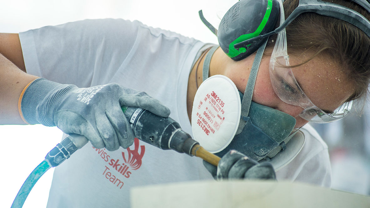 A competitor from Switzerland working with a machine.