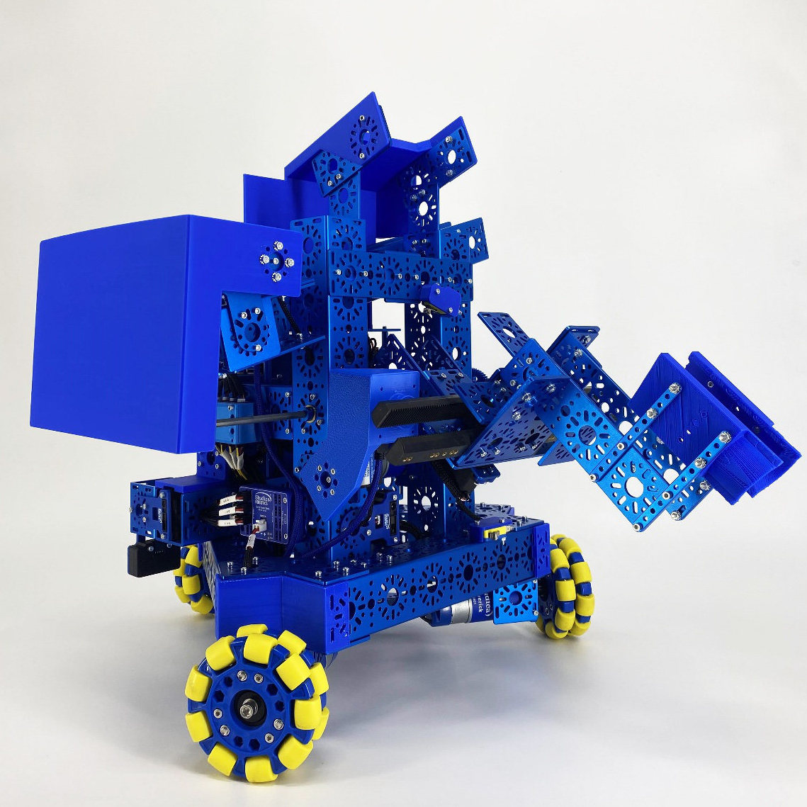 An image showing the details of a mobile robot by Studica Robotics including wheels and arm.