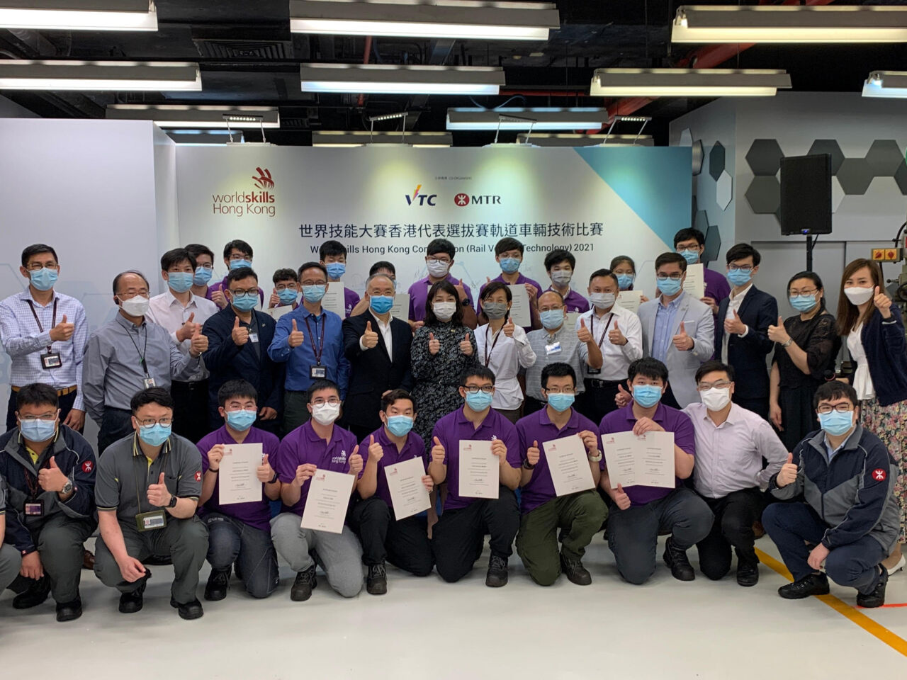 Competitors and experts pose with certificates at the end of the Rail Vehicle Technology competition in Hong Kong in May 2021.
