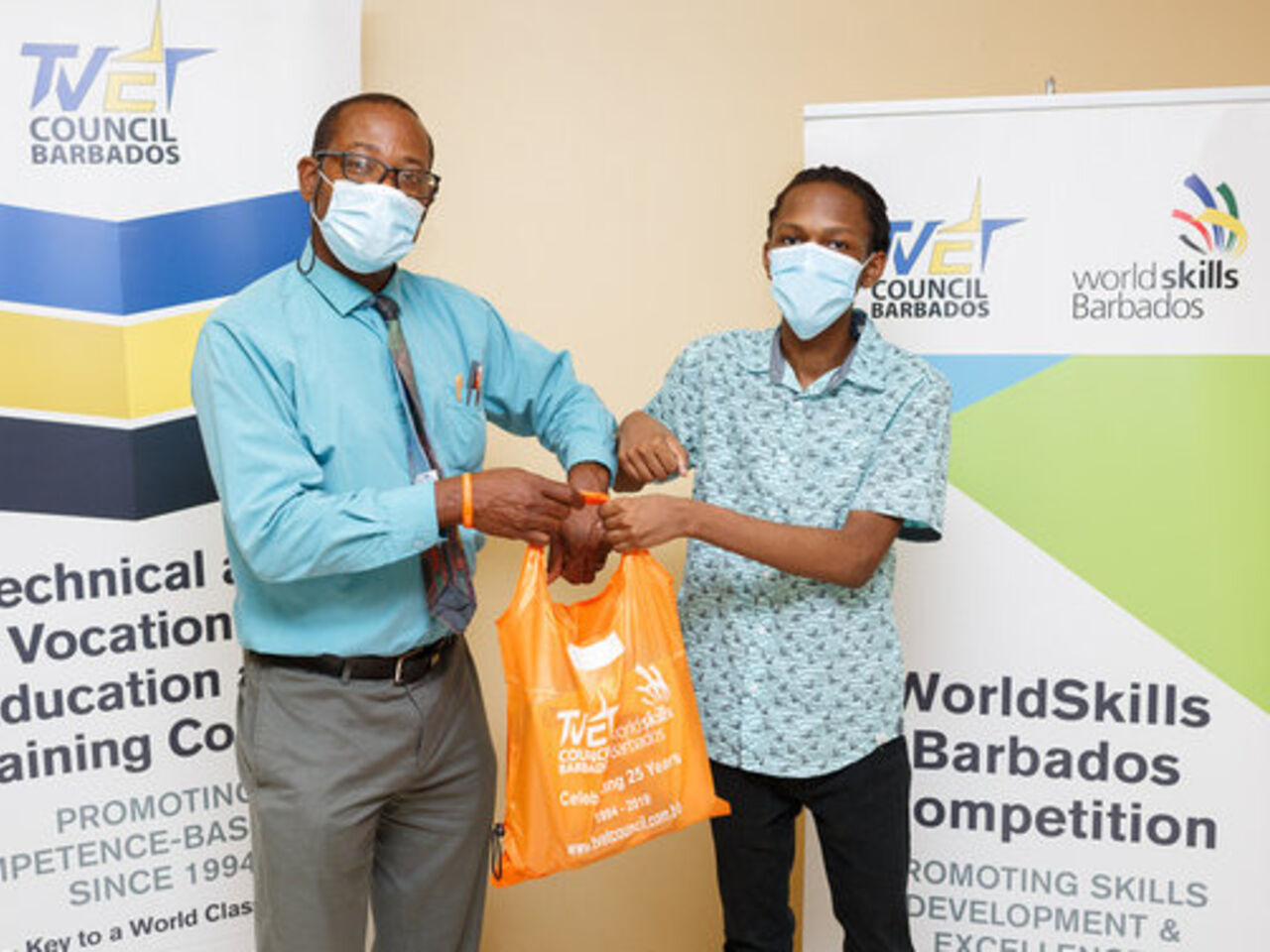 A student receives prizes for successfully completing WorldSkills Barbados Junior Future Skills Camp.
