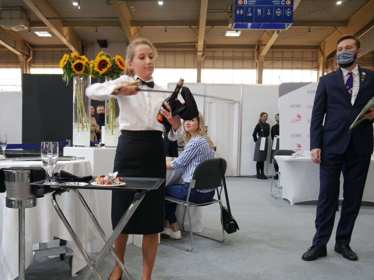 A competitor opening a bottle of champagne with a sword at the national competition in Poznań in 2020.
