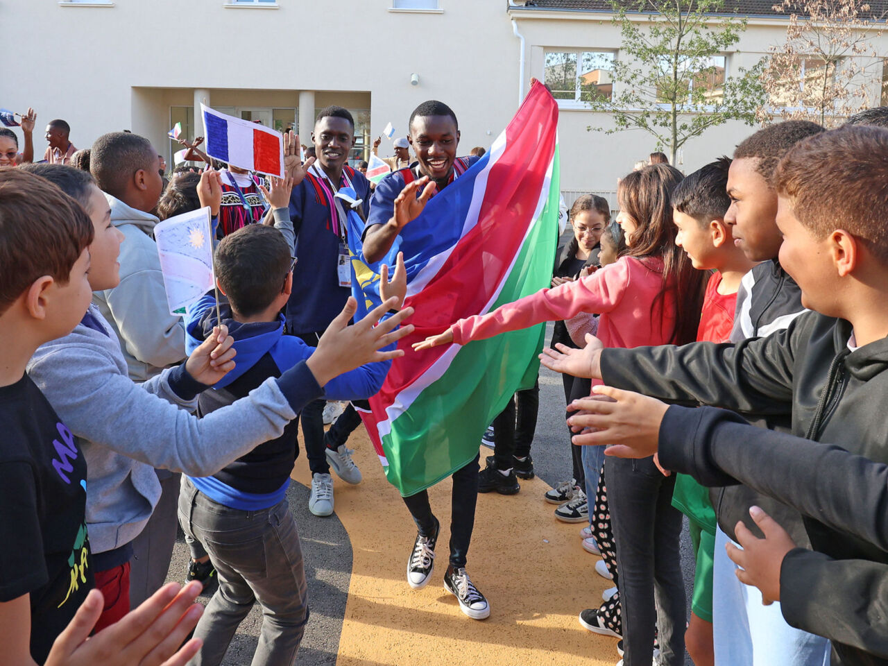 Competitors greeted by school children on 10 September 2024 as part of the cultural exchange programme One School One Country (OSOC).
