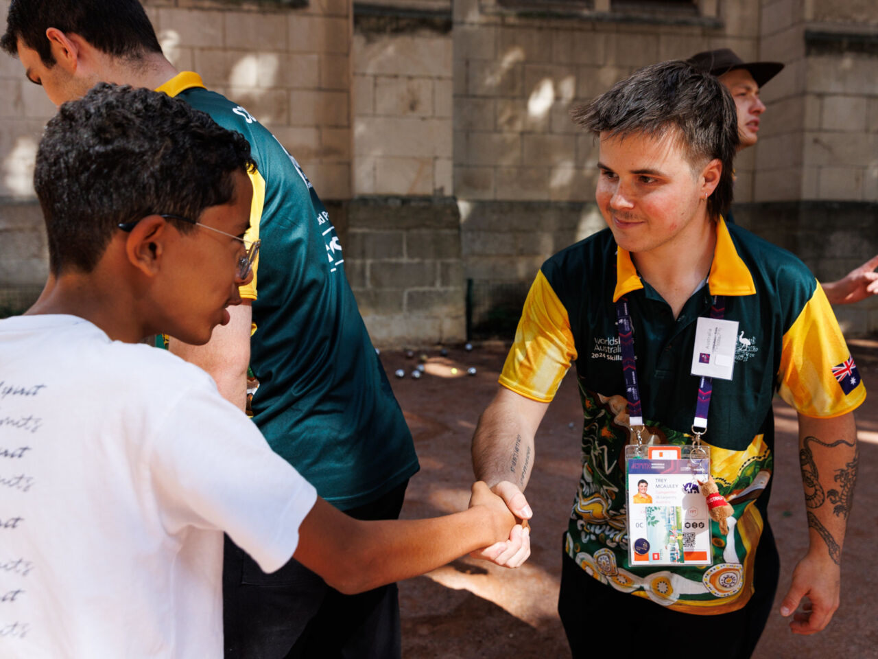 A Competitor meeting a child at a school on 10 September 2024 as part of the cultural exchange programme One School One Country (OSOC).
