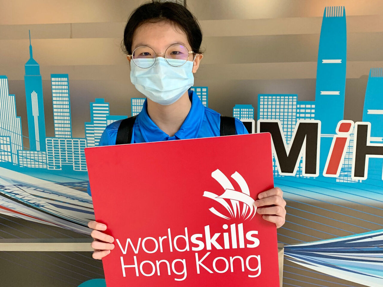 A competitor holds up a banner during the first Building Information Modelling competition by WorldSkills Hong Kong.
