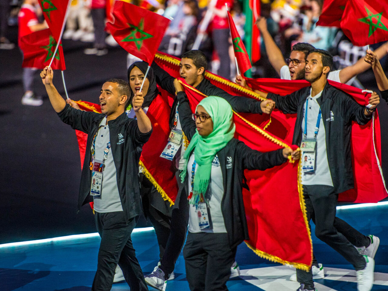 Yoursa Assali holding a Moroccan flag as part of the country's team during the Opening Ceremony at WorldSkills Kazan 2019 in Russia.
