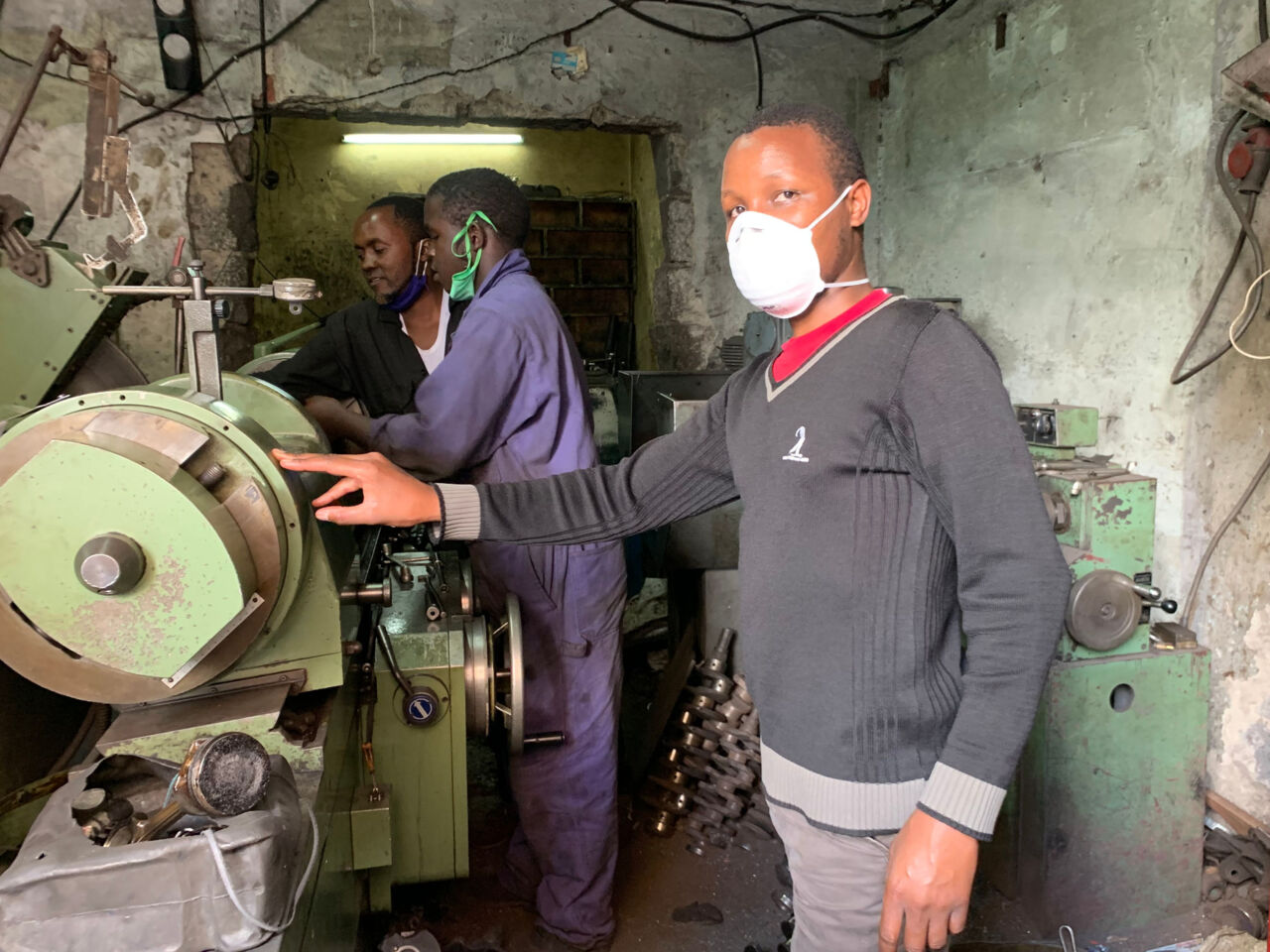 WorldSkills Kenya Technical Delegate Peter Monari checks on young people working in the automotive industry in Kenya.
