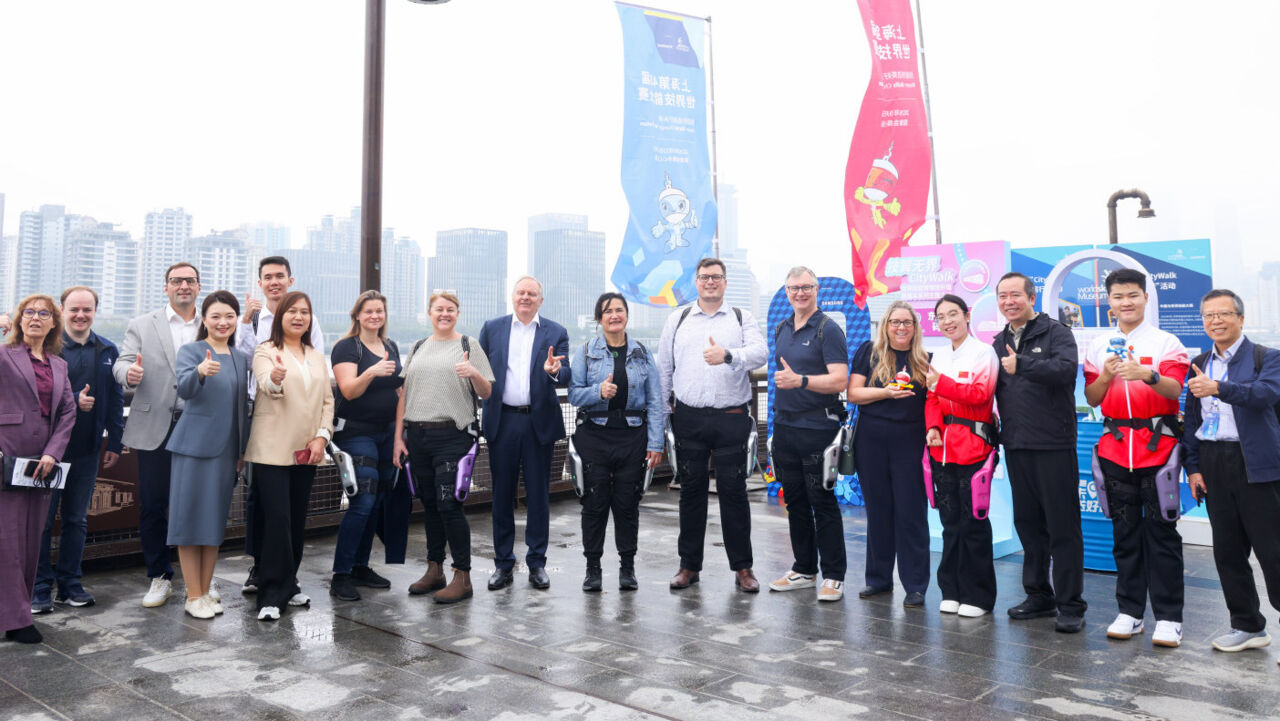 Representatives from WorldSkills International and the WorldSkills Champions Trust, WorldSkills Champions, alliance school members, and local officials take part in a walking event along the Yangpu Riverside.