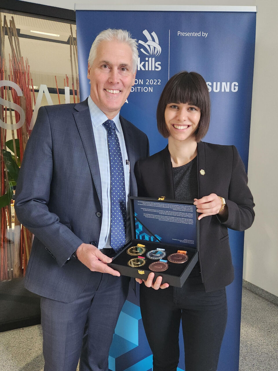 WorldSkills CEO David Hoey presenting Jacqueline Tanzer with a five-piece medal set in appreciation of her design work for WorldSkills Competition 2022 Special Edition at the final event in Salzburg, Austria in November 2022.