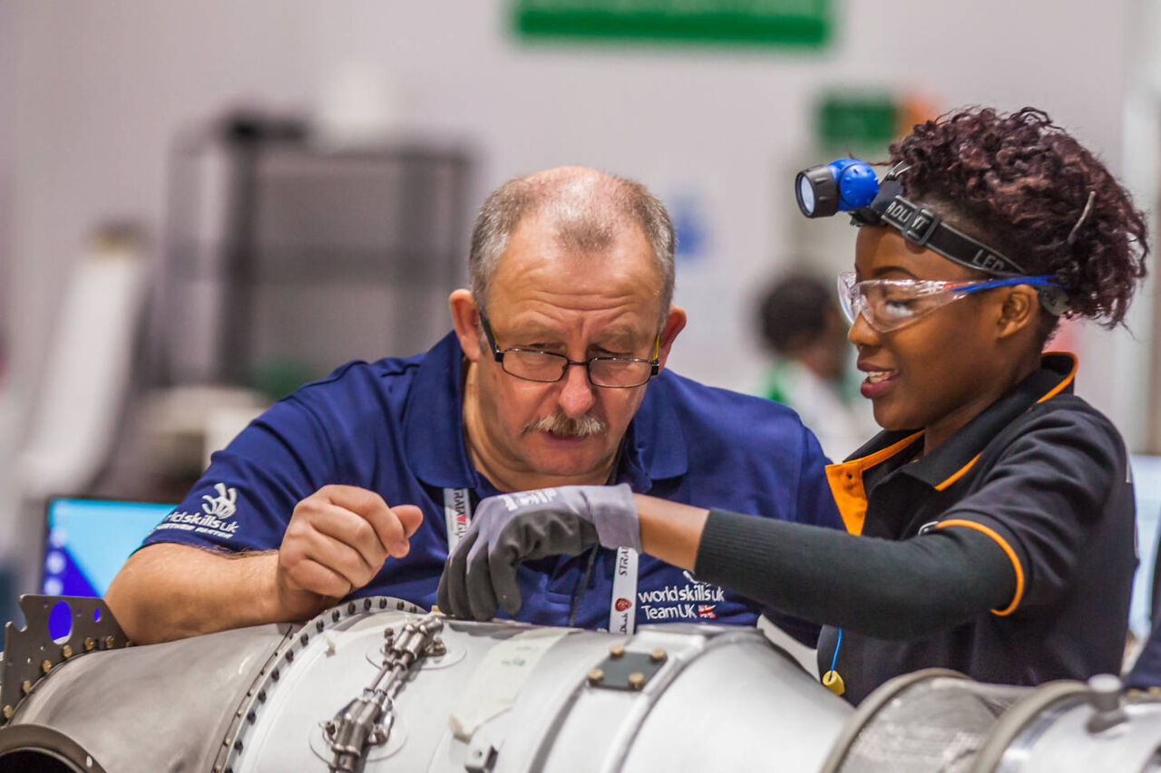 A WorldSkills Expert and a Competitor work on an aircraft engine as part of the Aircraft Maintenance skill competition. 