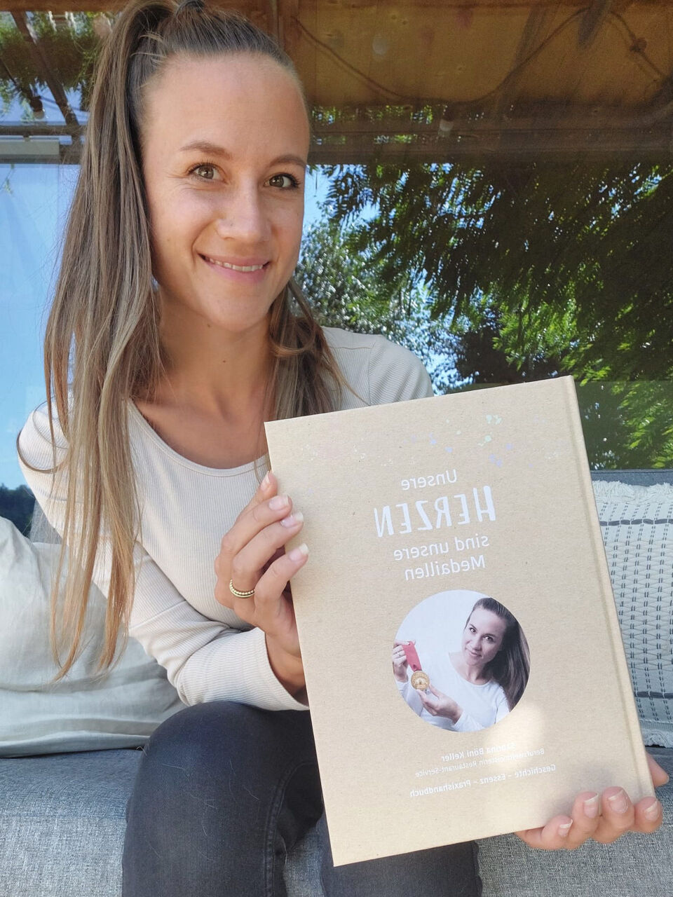 Sabrina Böni Keller, WorldSkills Champion, Expert, and Author from Switzerland, holding a copy of her new book.