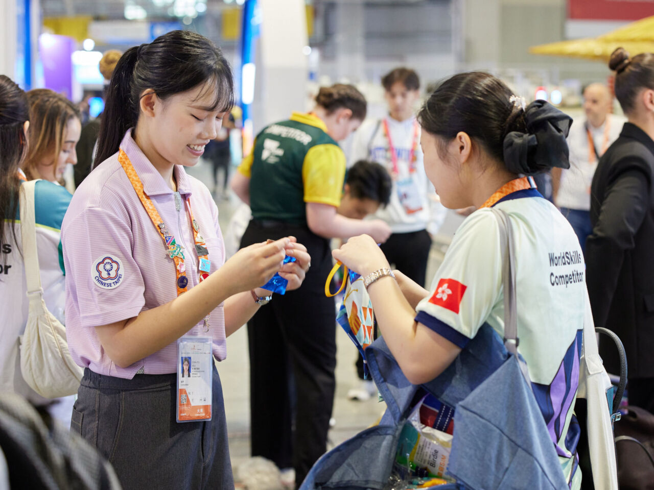 Competitors exchange pins during Familiarisation at WorldSkills Shanghai 2026.