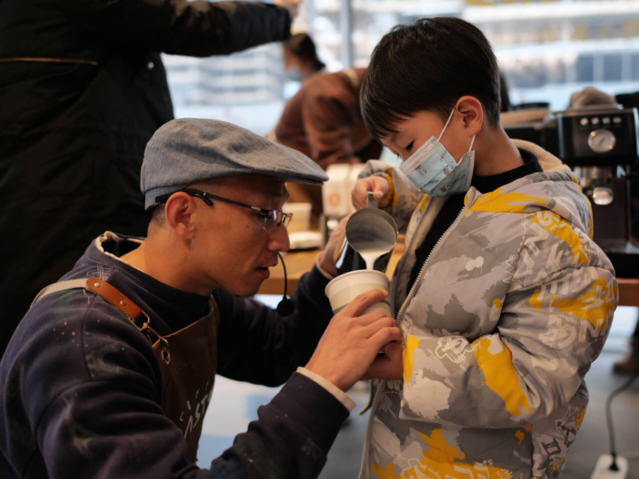 A father helps his son make coffee as part of the 2024 Spring Festival Skills Carnival at the WorldSkills Museum.