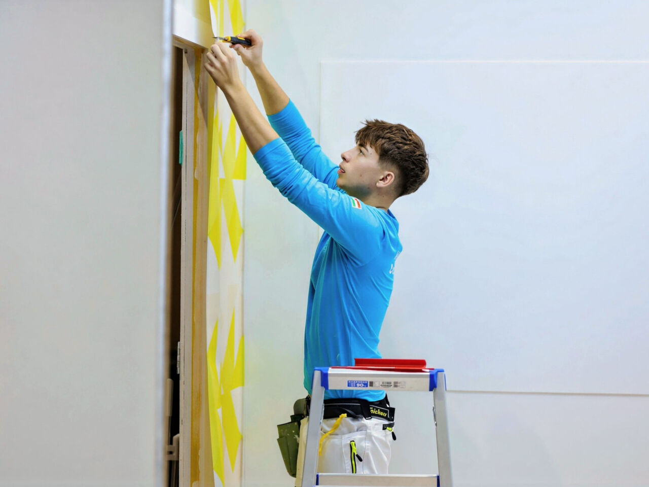 A competitor works on a wall during day 3 of WorldSkills Shanghai 2026.
