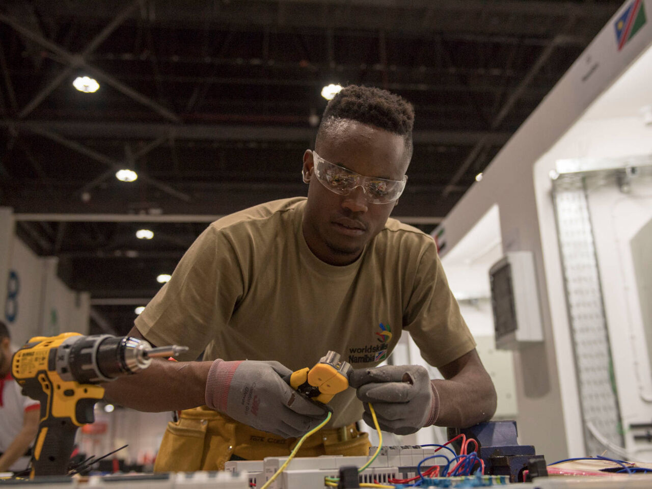 A competitor at a workbench during a skills competition.