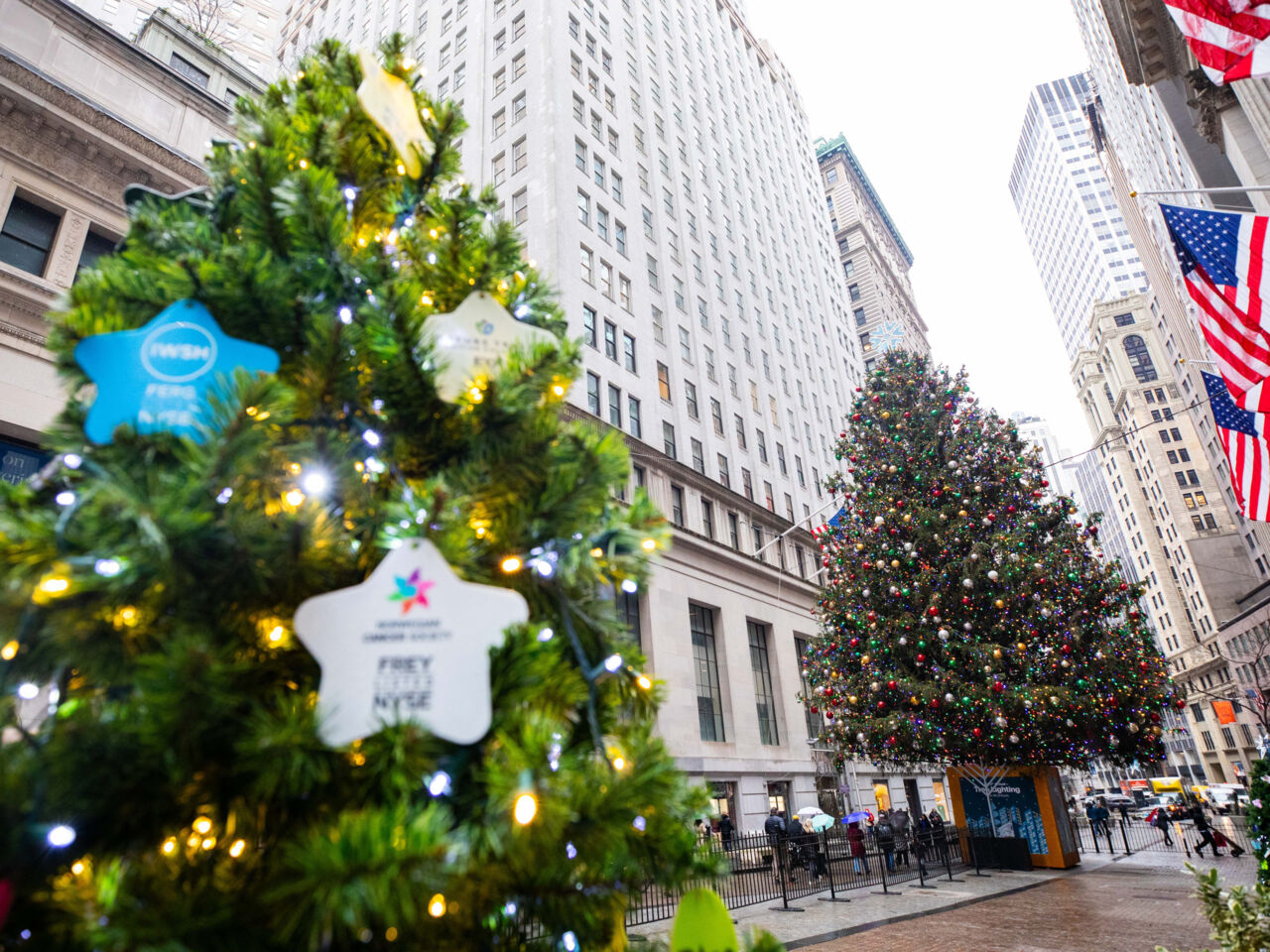 A wide shot of one of the New York Exchange Stock (NYSE) Christmas Trees at the corner of Wall and Broad Streets in New York. 