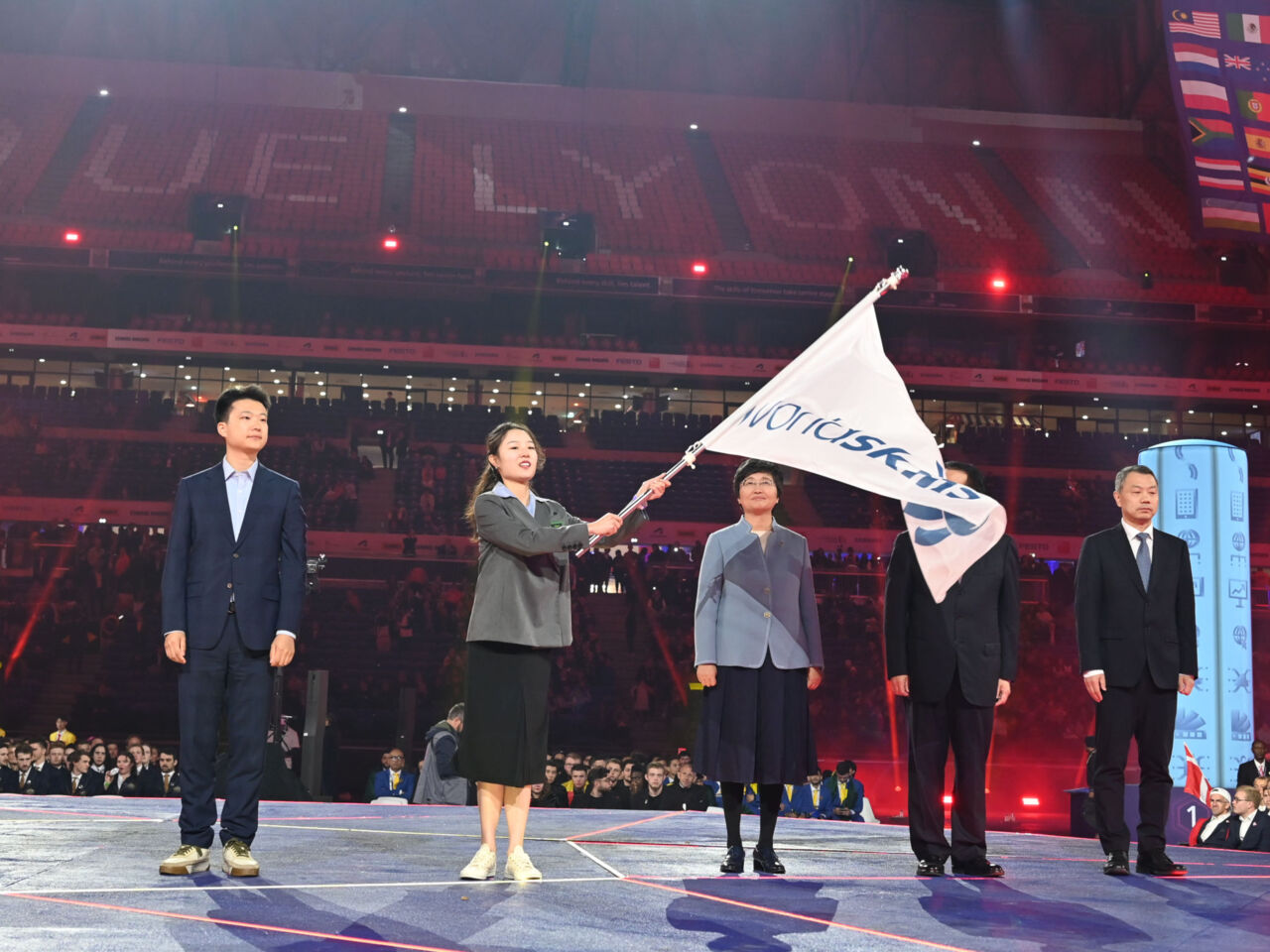 Representatives from China receiving the WorldSkills flag at the WorldSkills Lyon 2024 Closing Ceremony.