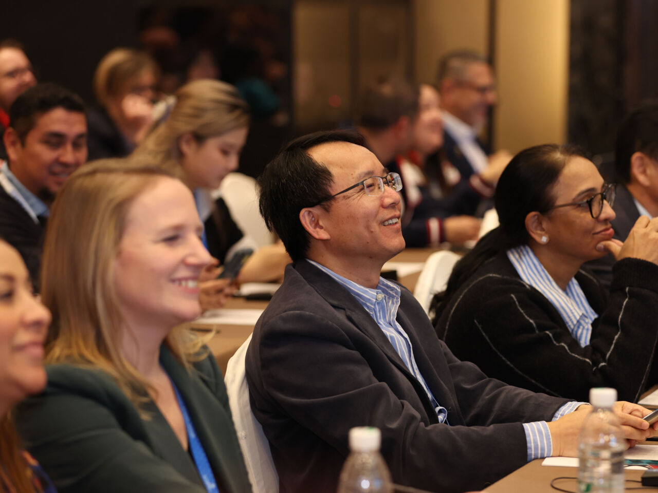 Delegates sat in the audience smile and laugh during one of the presentations at Competition Preparation Week in Shanghai in February 2026.